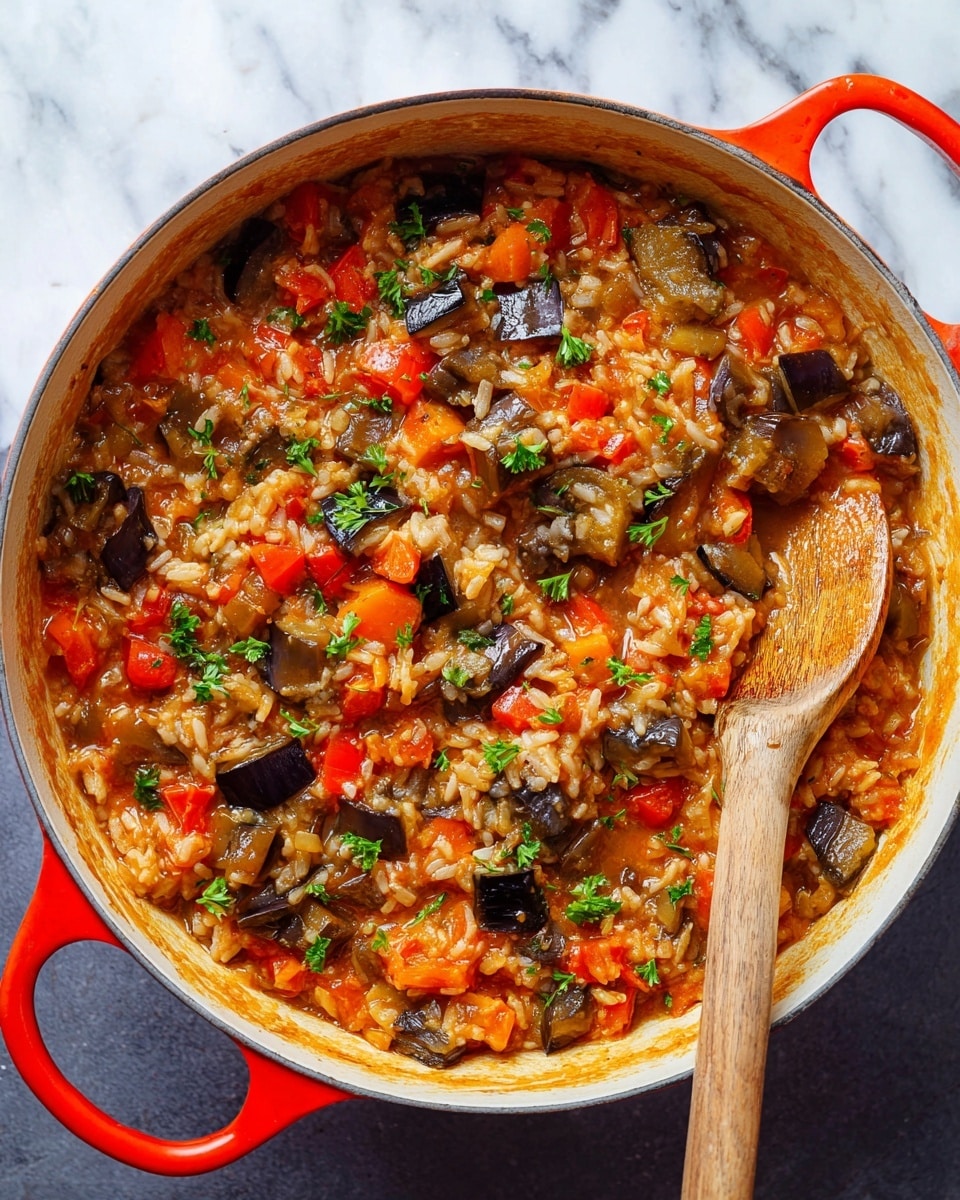 The image shows a close-up of a white cast iron pot filled with a colorful vegetable and rice stew, placed on a white marbled surface. The stew is a mix of cooked rice, diced red and orange bell peppers, chopped eggplants with dark purple skins, and finely grated carrots, all mixed in a thick, saucy base that is a warm orange-red color. Tiny green parsley leaves are scattered on top for garnish. A wooden spoon with a light brown handle is resting inside the pot on the right side, partially submerged in the stew. The pot’s bright red handles contrast with the white inside. photo taken with an iphone --ar 4:5 --v 7