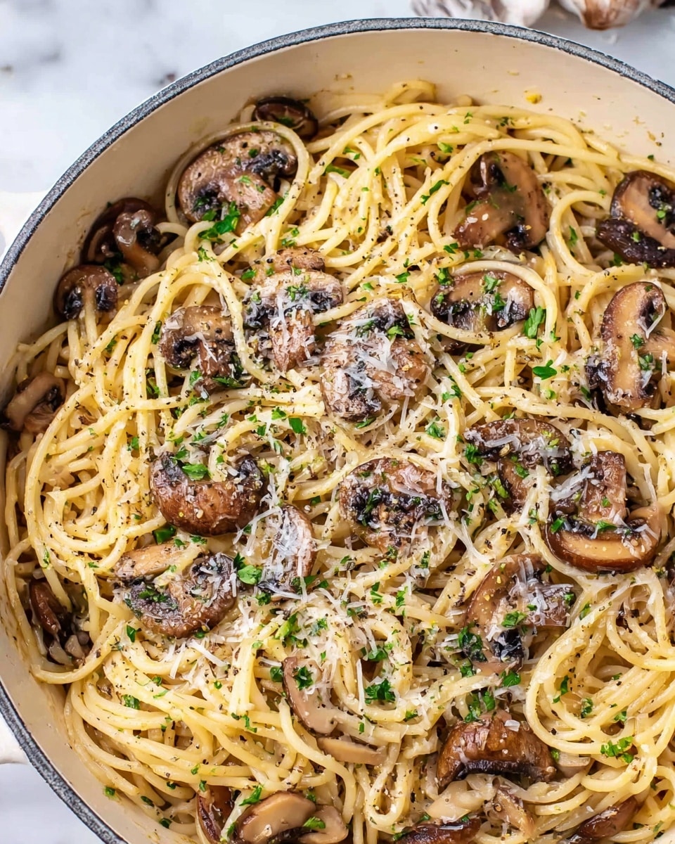 A close-up of a white pot filled with spaghetti pasta mixed with thick, sautéed mushroom slices, topped with finely chopped parsley and sprinkled with shredded white cheese and a dusting of black pepper. The pasta strands are a pale yellow, tangled and spread evenly throughout the pot, while the mushrooms are a rich brown with some darker, crisped edges. The green parsley adds small pops of color, and the cheese shreds create a light contrast against the pasta. The white pot sits on a white marbled surface, visible around the edges. Photo taken with an iphone --ar 4:5 --v 7